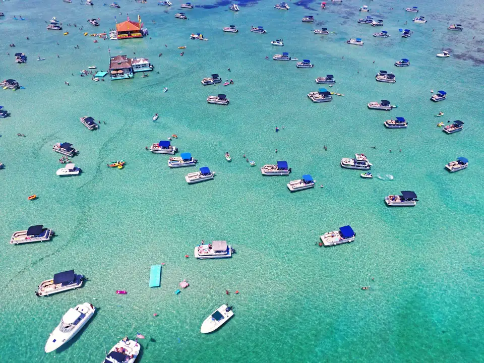 Boats anchored on the emerald sandbar shallows near Destin, Florida