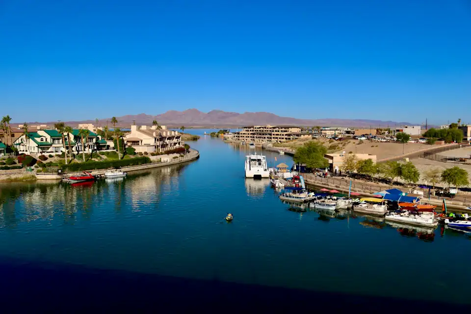 Boats in the marina channel at Lake Havasu City, Arizona with desert mountains behind