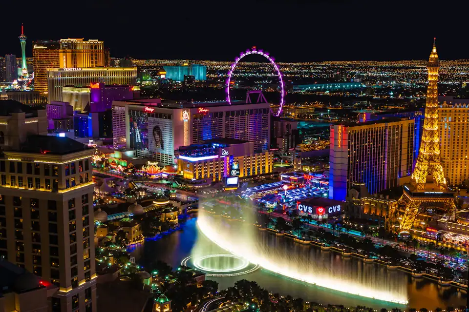 The Las Vegas Strip illuminated at night with the Bellagio fountains in the foreground