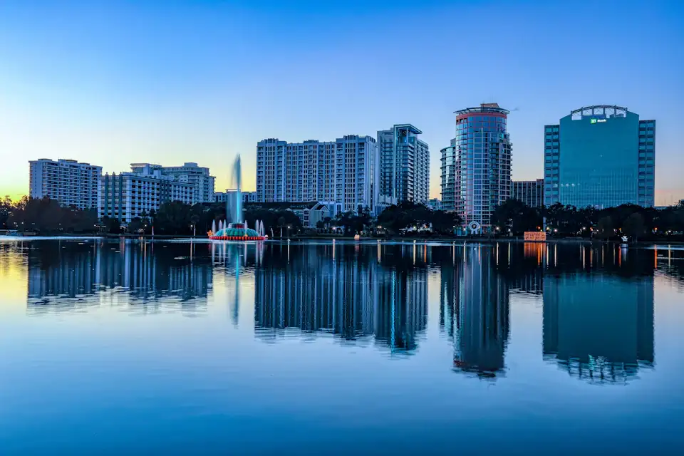 Downtown Orlando skyline reflecting in Lake Eola at dusk