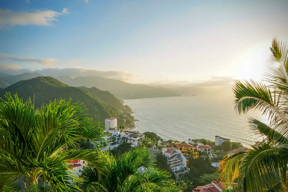 Lush green hills meeting the Pacific coastline in Puerto Vallarta, Mexico at sunset