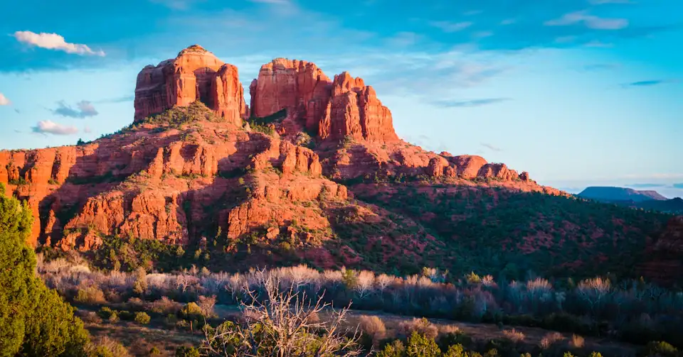 Cathedral Rock glowing red against a blue sky in Sedona, Arizona